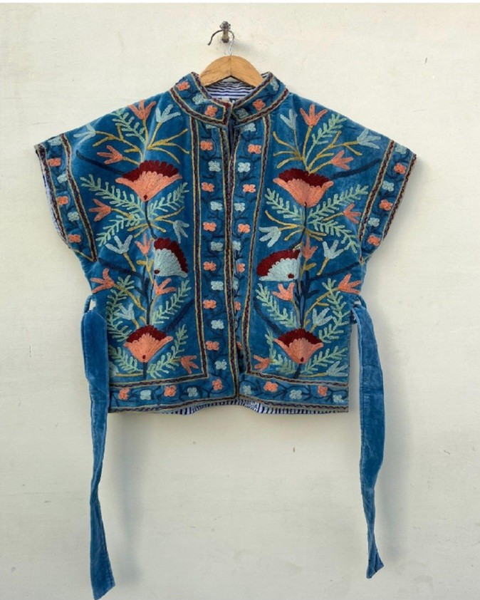 a teal suzani vest with floral design